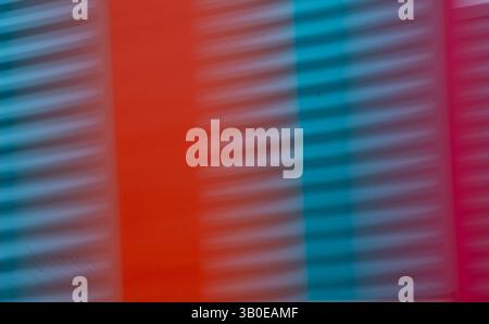 abstract blur of red orange and blue or turquoise corrugated metal special blurry effect created by long time exposure and intentional camera movement Stock Photo