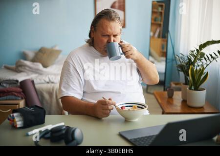 Enjoying Breakfast While Working From Home Stock Photo