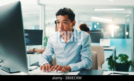 Coding, man and typing on computer in office for app development, software maintenance and testing website. Professional, employee and technology for Stock Photo