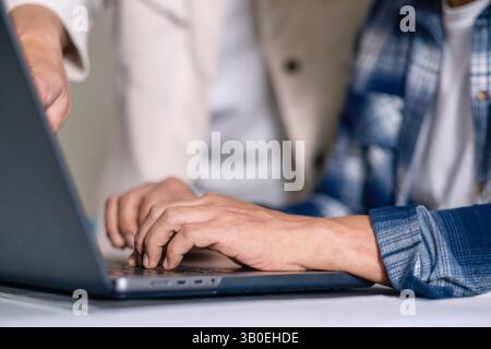 Senior male participating in a computer programming bootcamp, improving skills and learning coding Stock Photo