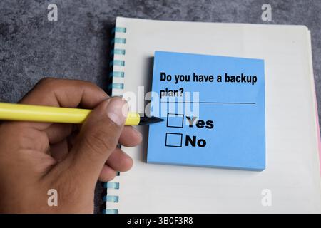 Concept of Do you have a backup plan yes or no write on sticky notes isolated on Wooden Table. Stock Photo