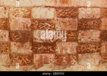 Textured, patterned stone wall in the design of an abstract checkerboard for background or graphic design Stock Photo