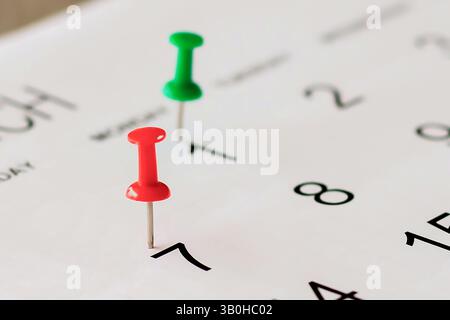 Embroidered pins on a calendar appointment Stock Photo