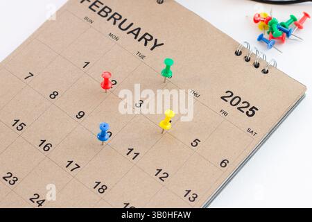 Embroidered pins on a calendar appointment Stock Photo