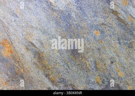 Rustic Stone Tile Texture with Weathered Gray and Warm Orange Accents Stock Photo