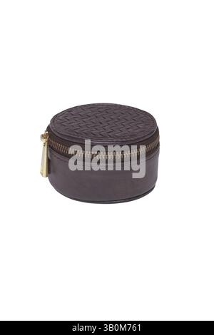 small, round, brown leather jewelry case with a zipper closure this elegant travel container offers secure storage with its sophisticated woven textur Stock Photo