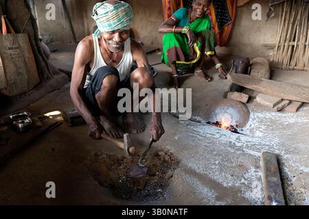 Local blacksmith working in a small workshop in a village in rural part of orissa in india Stock Photo