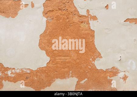 Peeling Wall with Exposed Red Plaster Stock Photo