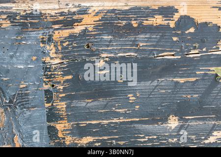 Black Painted Wooden Surface with Peeling Layers Stock Photo