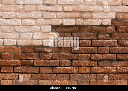 Contrast of Painted and Exposed Brick Wall Stock Photo