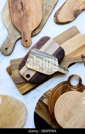 Assorted Wooden Cutting Boards on Marble Kitchen Surface Stock Photo