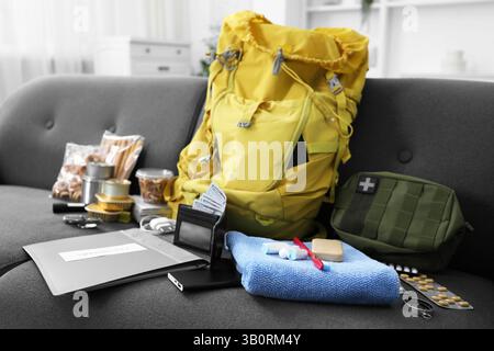 Survival kit. Different emergency supplies on sofa indoors Stock Photo
