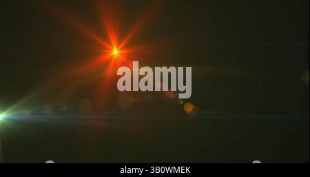 Image of glowing spots of lights over dark background Stock Photo
