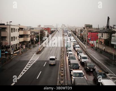 Urban Traffic Jam on Elevated Roadway during Rainy Day in Tokyo Suburbs Stock Photo