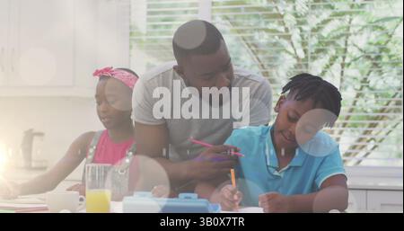 Image of bokeh over happy african american father and children in kitchen Stock Photo