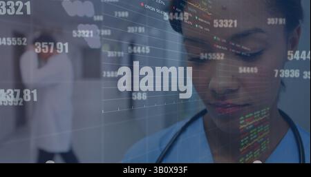 Image of financial data over biracial female doctor making notes Stock Photo