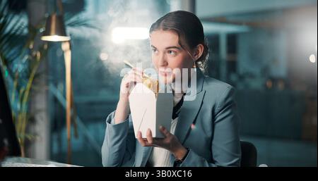 Business, woman and eating fast food in office for working break, project deadline and proofreading newsletter. Night, journalist and chinese takeout Stock Photo