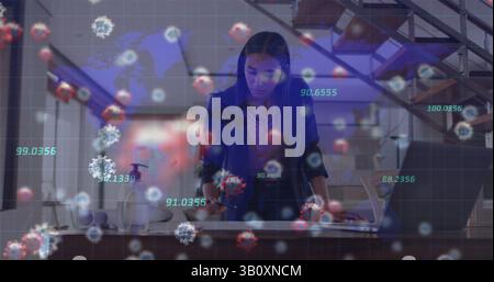 Image of virus cells and numbers over biracial woman working in office Stock Photo