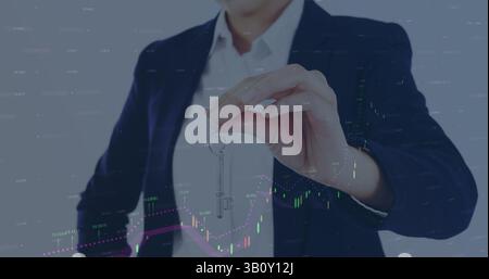 Statistical data processing against mid section of caucasian female real estate agent holding a key Stock Photo