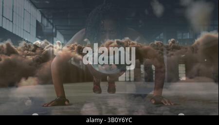 Image of clouds over african american sportswoman doing push ups Stock Photo