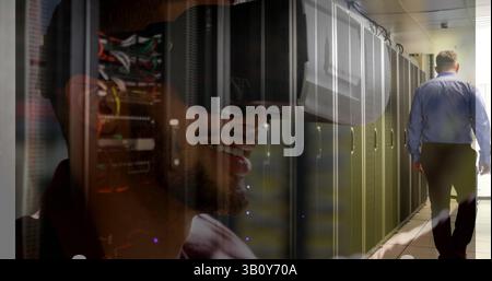 Image of server room over biracial man using vr headset Stock Photo