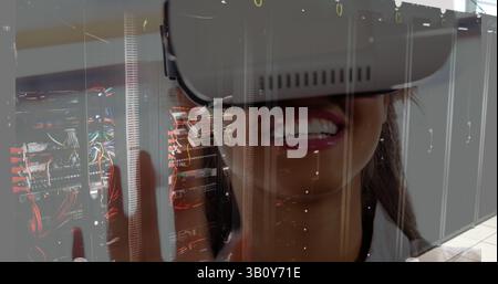 Image of server room over biracial woman using vr headset Stock Photo