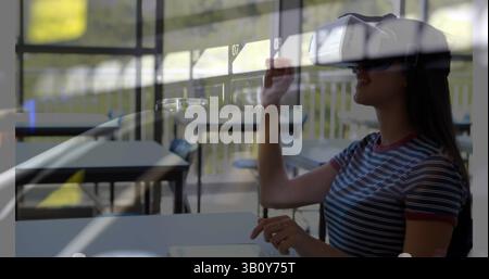 Image of server room over biracial woman using vr headset Stock Photo