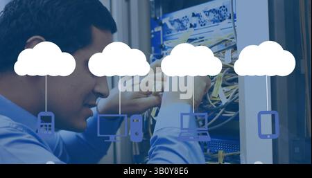 Image of media icons over biracial male worker inspecting server room Stock Photo