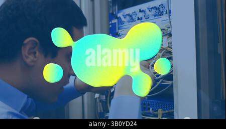 Image of stains over biracial male worker inspecting server room Stock Photo