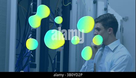 Image of stains over caucasian male worker inspecting server room Stock Photo