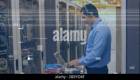 Image of glitch over caucasian man checking servers Stock Photo
