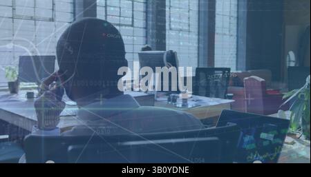 Image of financial data and binary coding over african american businessman using smartphone Stock Photo