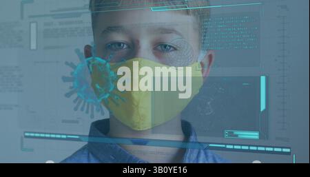 Facing camera boy wearing yellow protective face mask in virtual lab, with 3D virus graphic Stock Photo