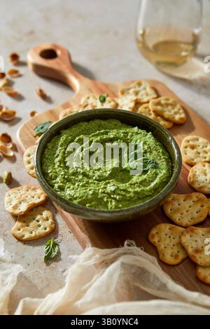 Basil Feta Pistachio Dip with Crackers on a Cutting Board Stock Photo