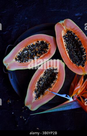 Ripe tropical papaya fruit on black background. Stock Photo
