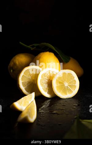 Sliced fresh lemons on a dark background Stock Photo