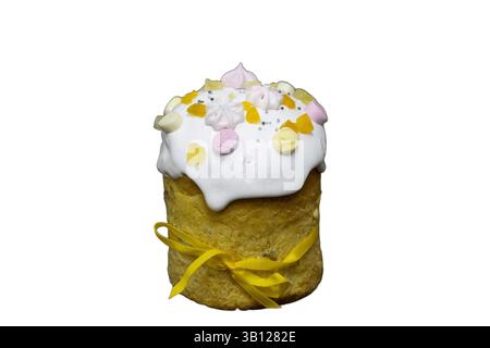 Traditional Easter cake known as Kulich, decorated with white icing, colorful candy, meringue, dried fruits, and tied with a yellow ribbon. Stock Photo