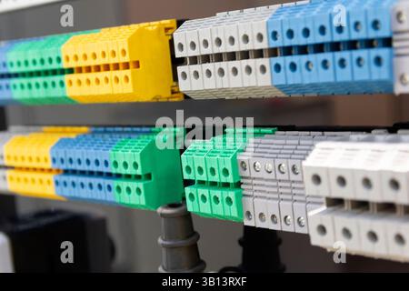 New terminal blocks located on a DIN rail at the exhibition stand. Industry Stock Photo