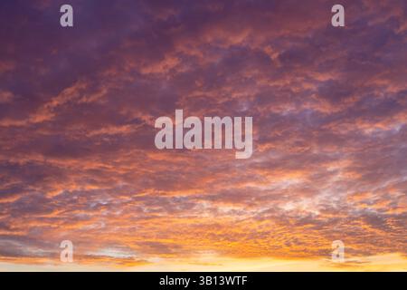Dramatic orange and purple sunset clouds sky background Stock Photo