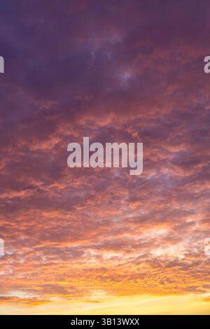 Dramatic orange and purple sunset clouds sky background Stock Photo