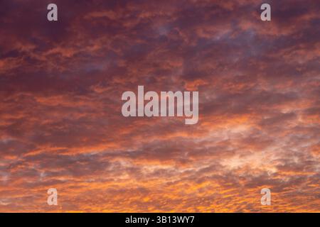 Dramatic orange and purple sunset clouds sky background Stock Photo