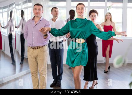 Men and women dancers standing in pairs in dance studio Stock Photo