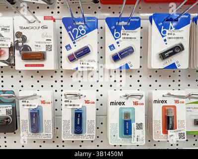 Usb flash drives display on pegboard with various storage capacities. Stock Photo