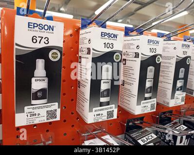 Epson ink refill bottles on display shelf in retail store. Stock Photo