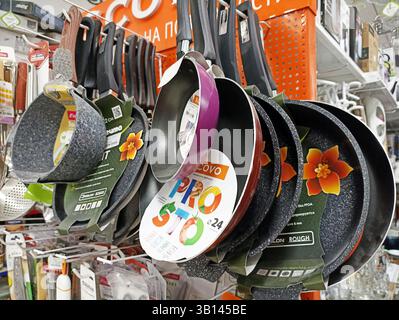 Variety of nonstick frying pans displayed in kitchenware store. Stock Photo