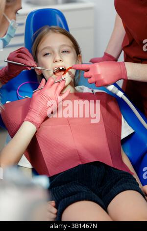 teeth whitening, dentist checking teeth, dental examination, patient's teeth, hospital office, ensuring dental health Stock Photo