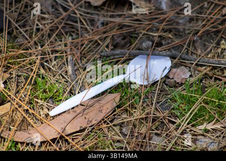 white plastic utensils on ground Stock Photo