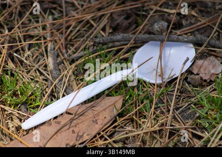 white plastic utensils on ground Stock Photo