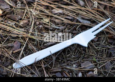 white plastic utensils on ground Stock Photo