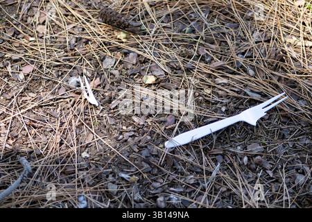 white plastic utensils on ground Stock Photo